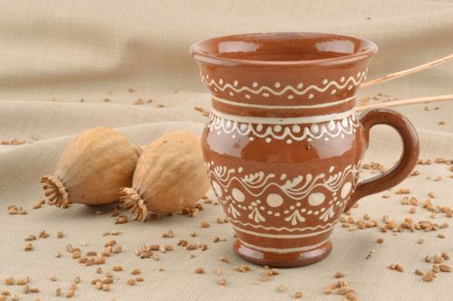 Decorative clay glazed drinking cup in pitcher shape with handle and white ethnic pattern - MADEheart.com