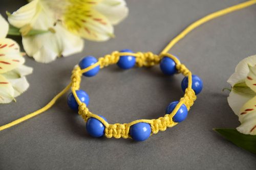 Handmade friendship bracelet woven of yellow cord and blue beads for children - MADEheart.com