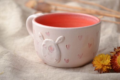 White and orange ceramic 5 oz teacup with molded rabbit and a handle - MADEheart.com