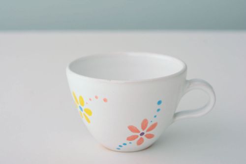 White ceramic drinking handmade 5 oz cup with handle and orange-blue flowers pattern - MADEheart.com