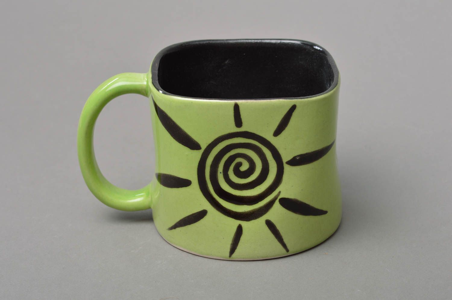 Light green and black porcelain coffee mug with handle and cave drawings sun picture photo 1