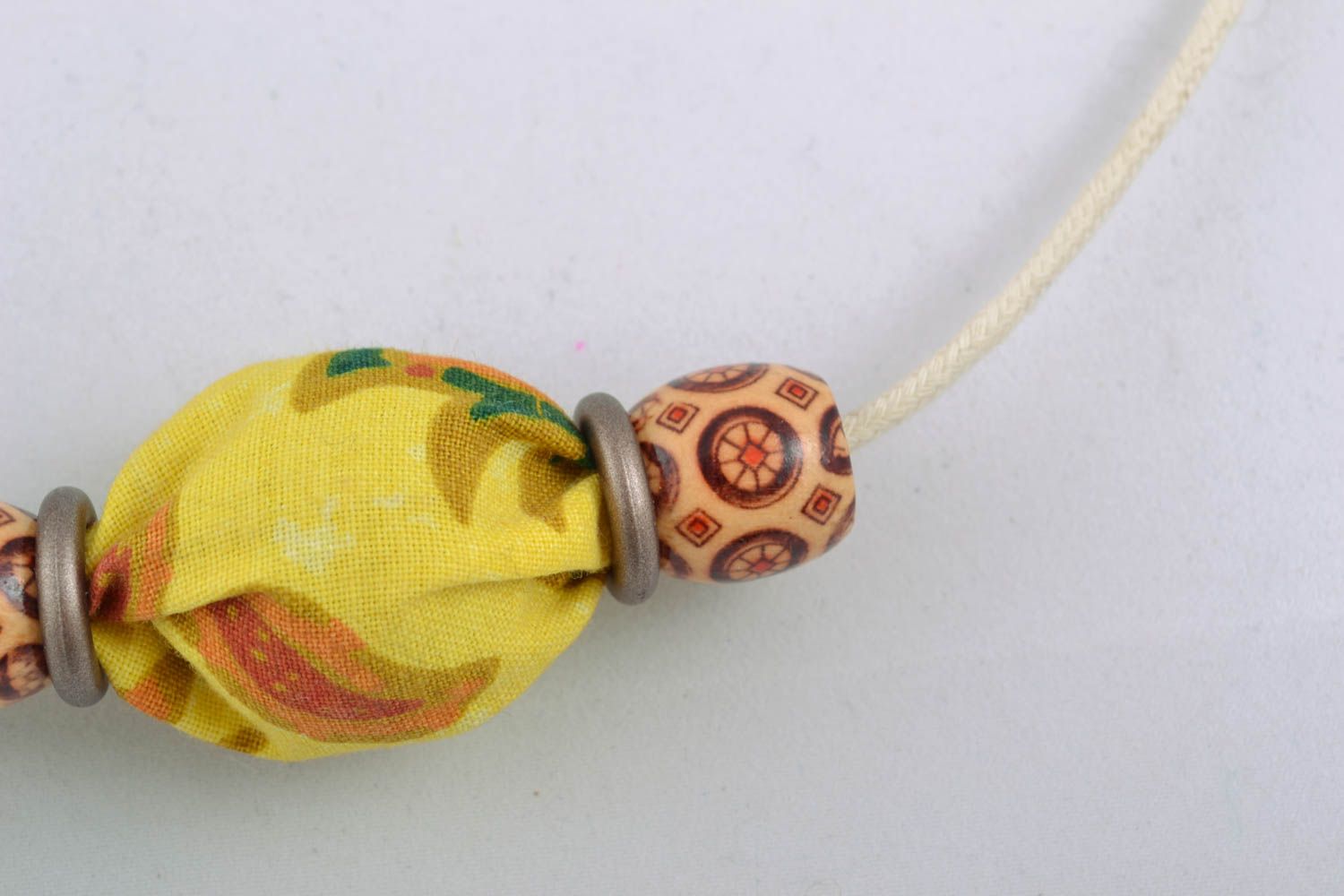 Textile necklace with wooden beads and nuts photo 2