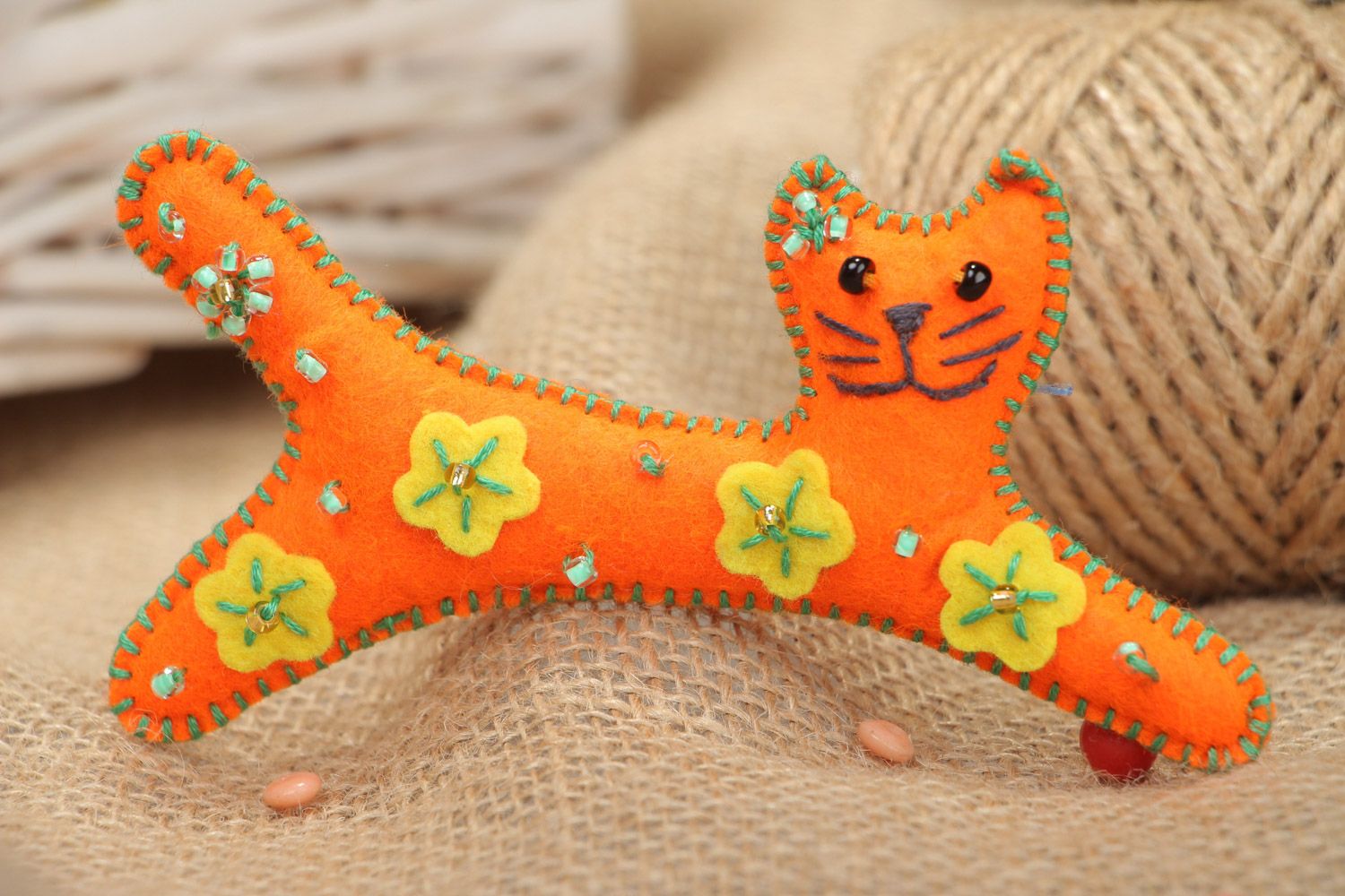 Handmade small soft toy sewn of felt in the shape of long orange kitten  photo 1