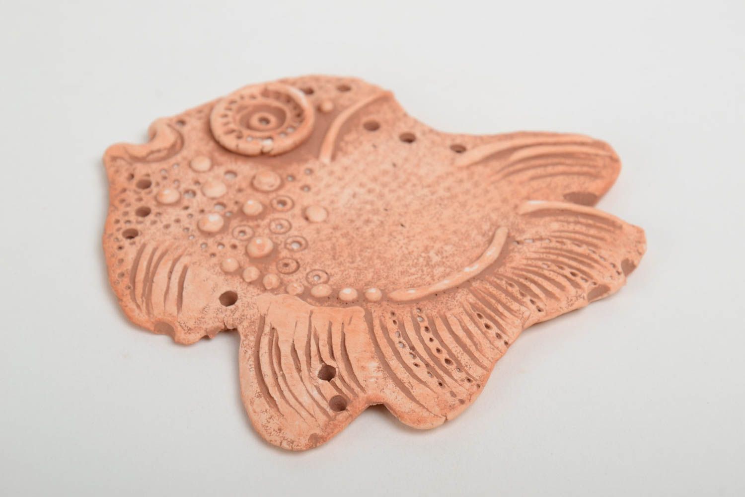 Homemade flat pendant molded of pottery clay in the shape of decorative fish photo 4