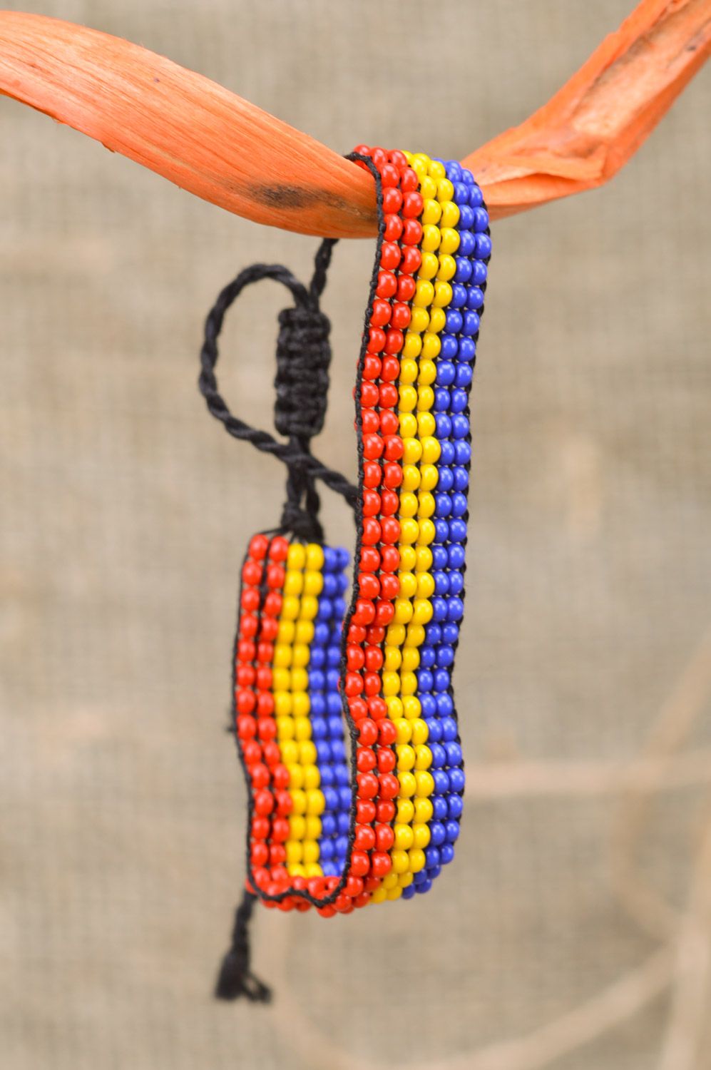 Beautiful stylish handmade women's wrist bracelet woven of three-colored beads and threads photo 1