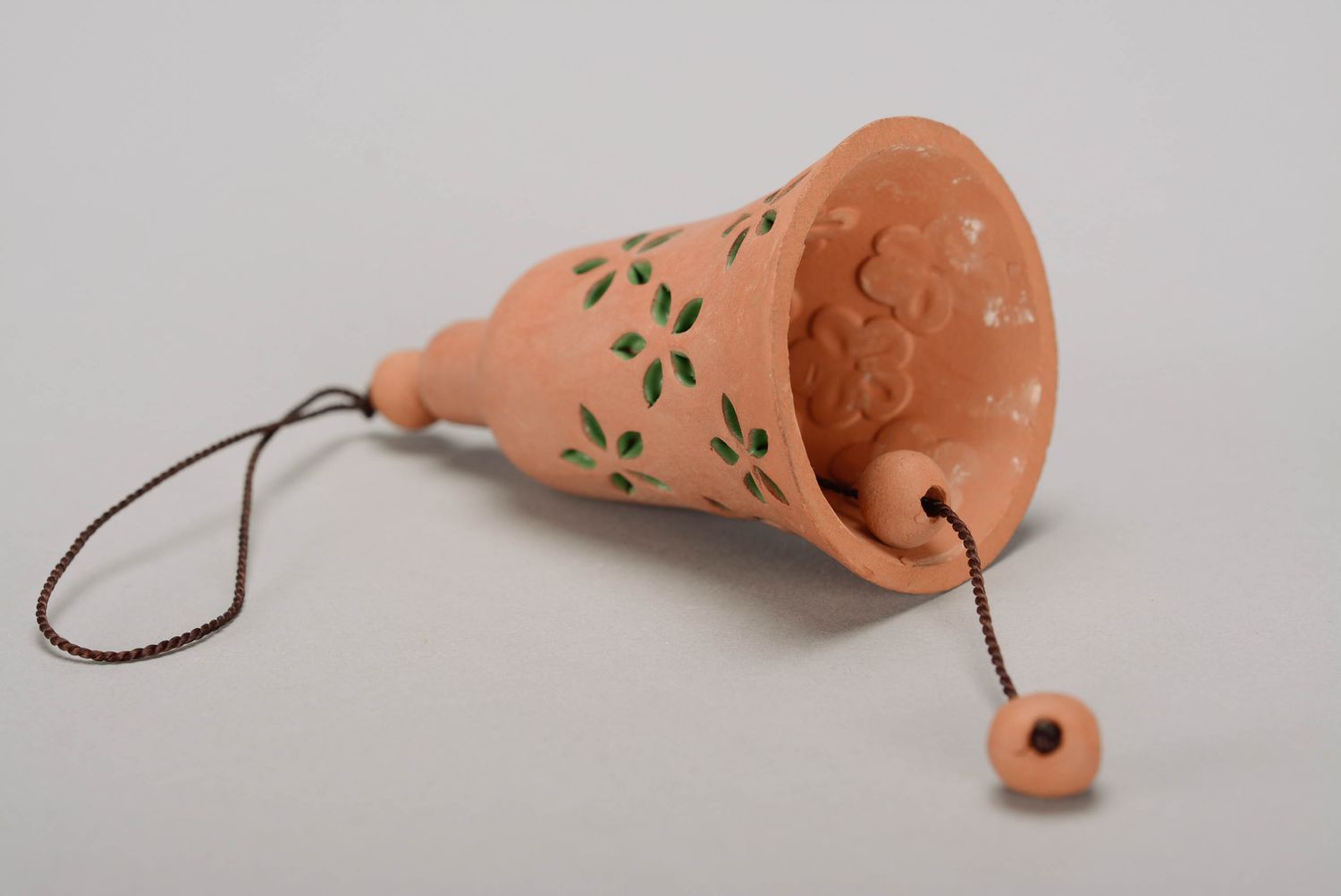 Bell made from red clay with embossment photo 1