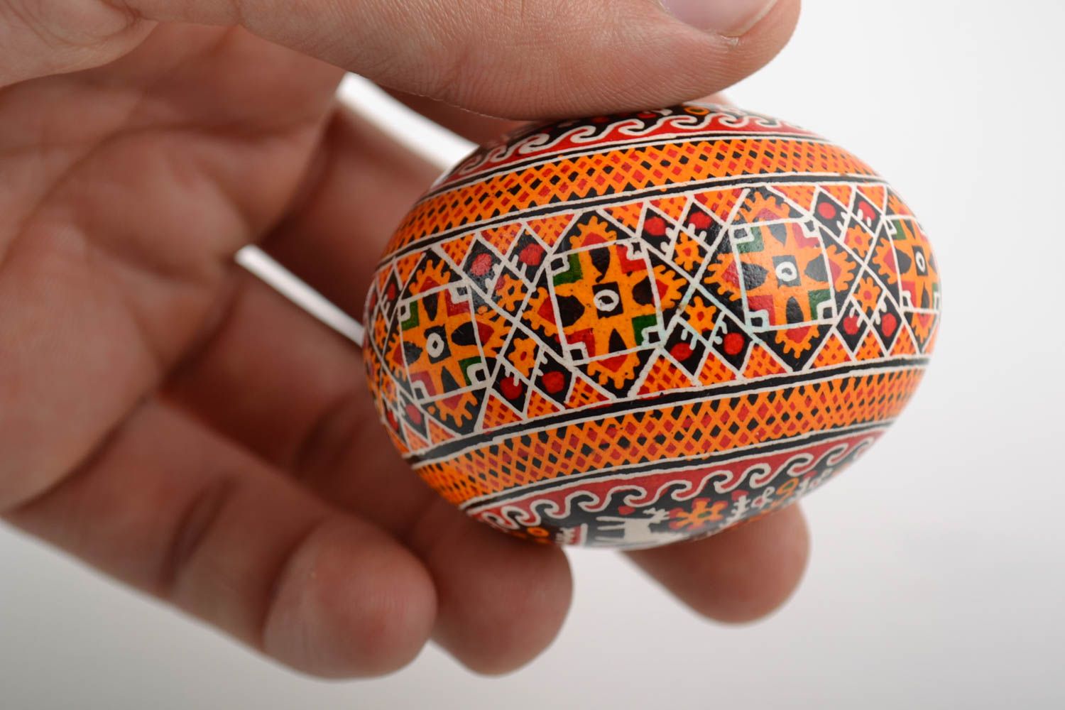 Handmade painted Easter egg with pattern in orange color palette home decor photo 2