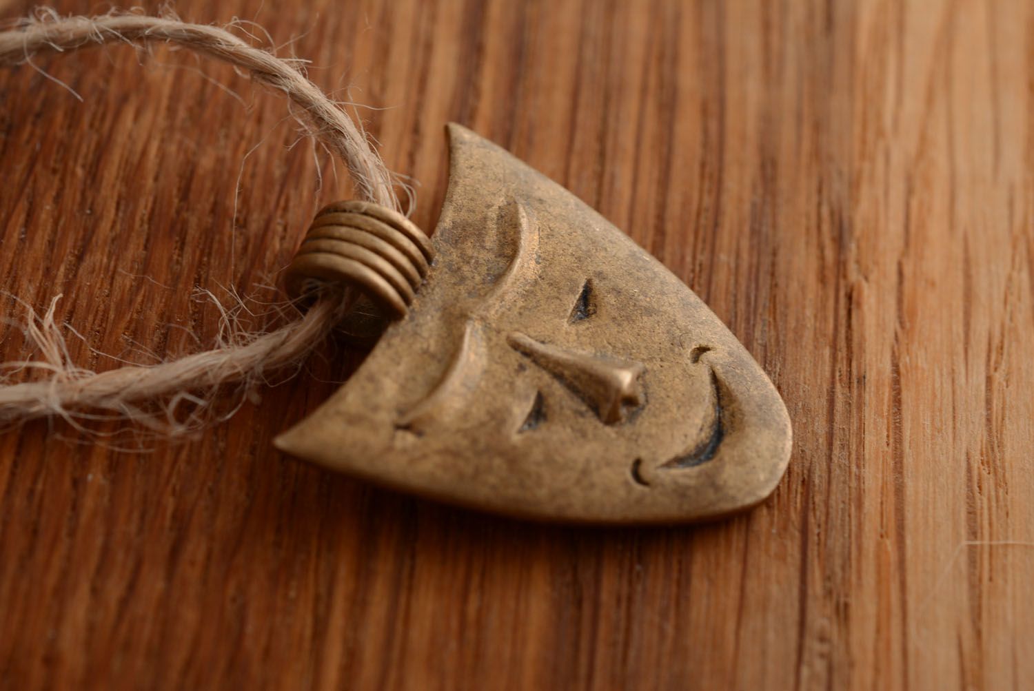 Bronze pendant in the shape of a mask photo 1