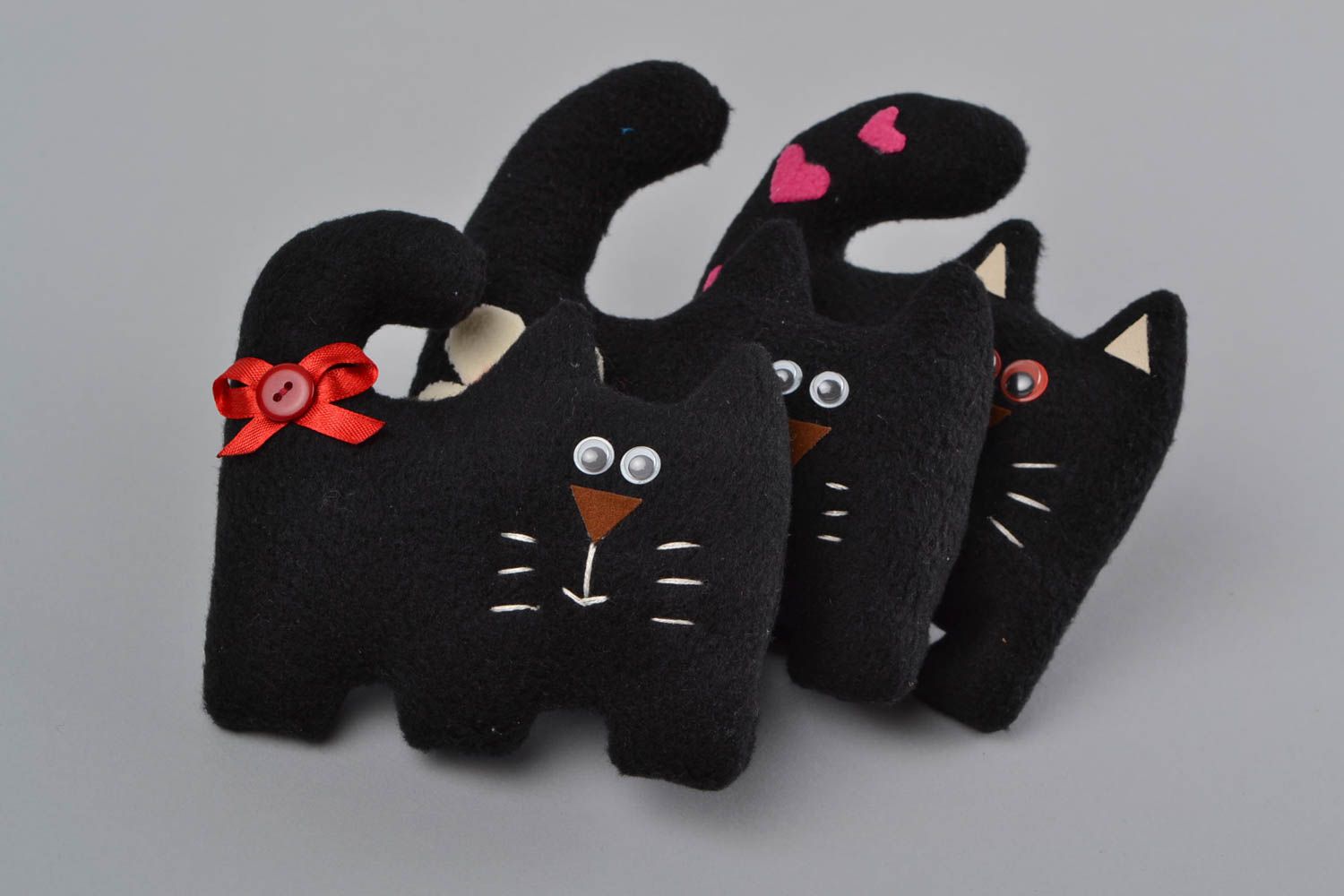 Handmade small soft toy sewn of black fleece in the shape of cat with red bow photo 1