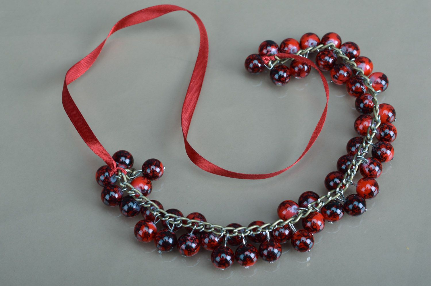 Handmade necklace woven of ceramic beads of saturated garnet color on ribbon photo 2