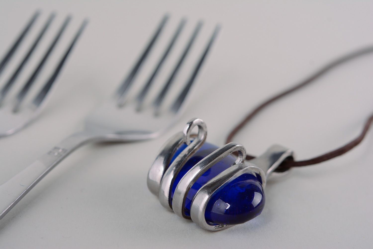Homemade metal pendant made of cupronickel fork with blue artificial stone photo 1