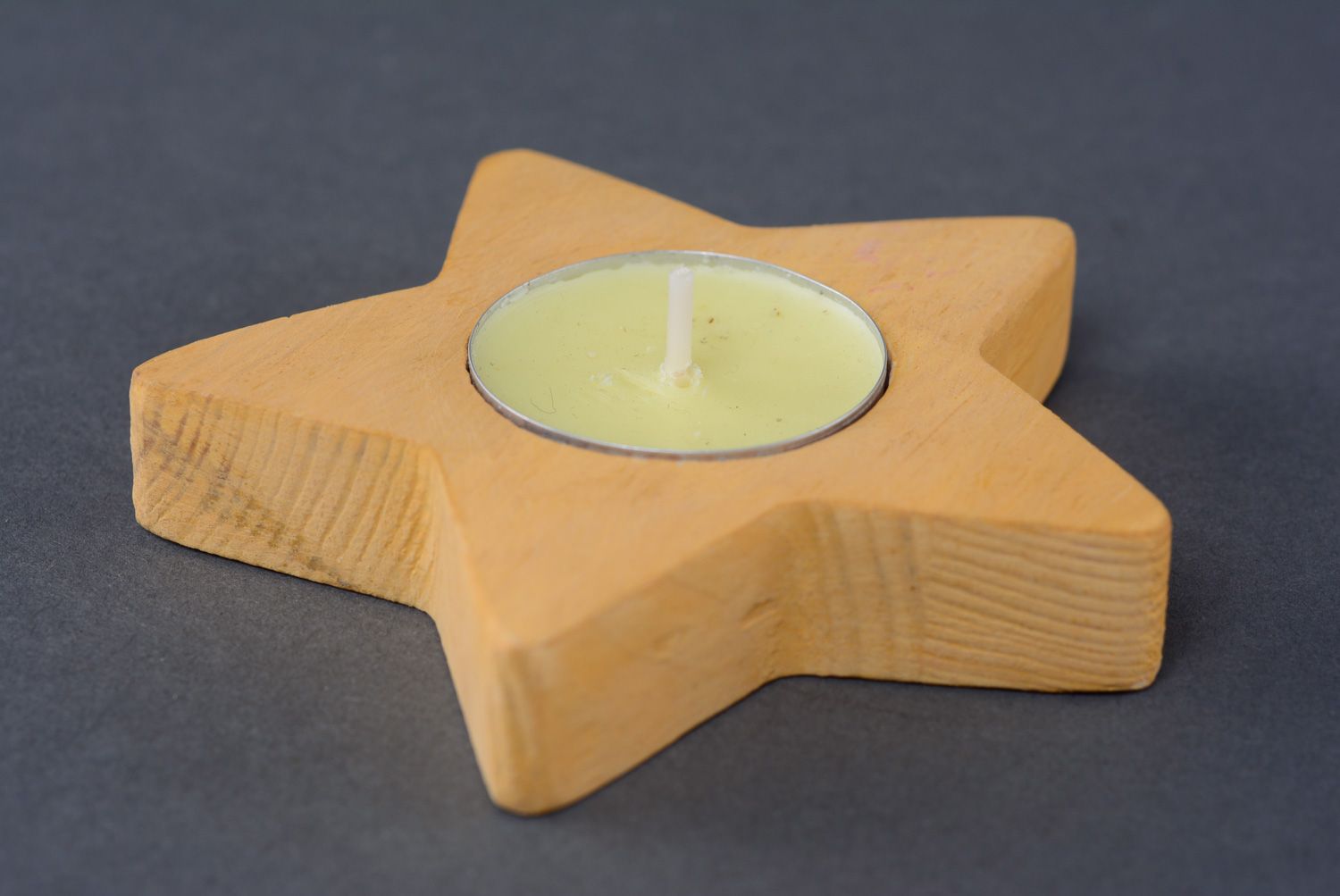 Yellow wooden candlestick in the shape of star photo 2