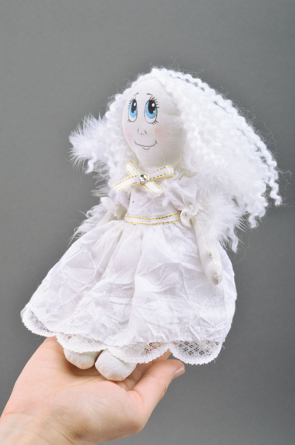 Handmade white fabric soft doll of average size with wings made of feathers photo 3