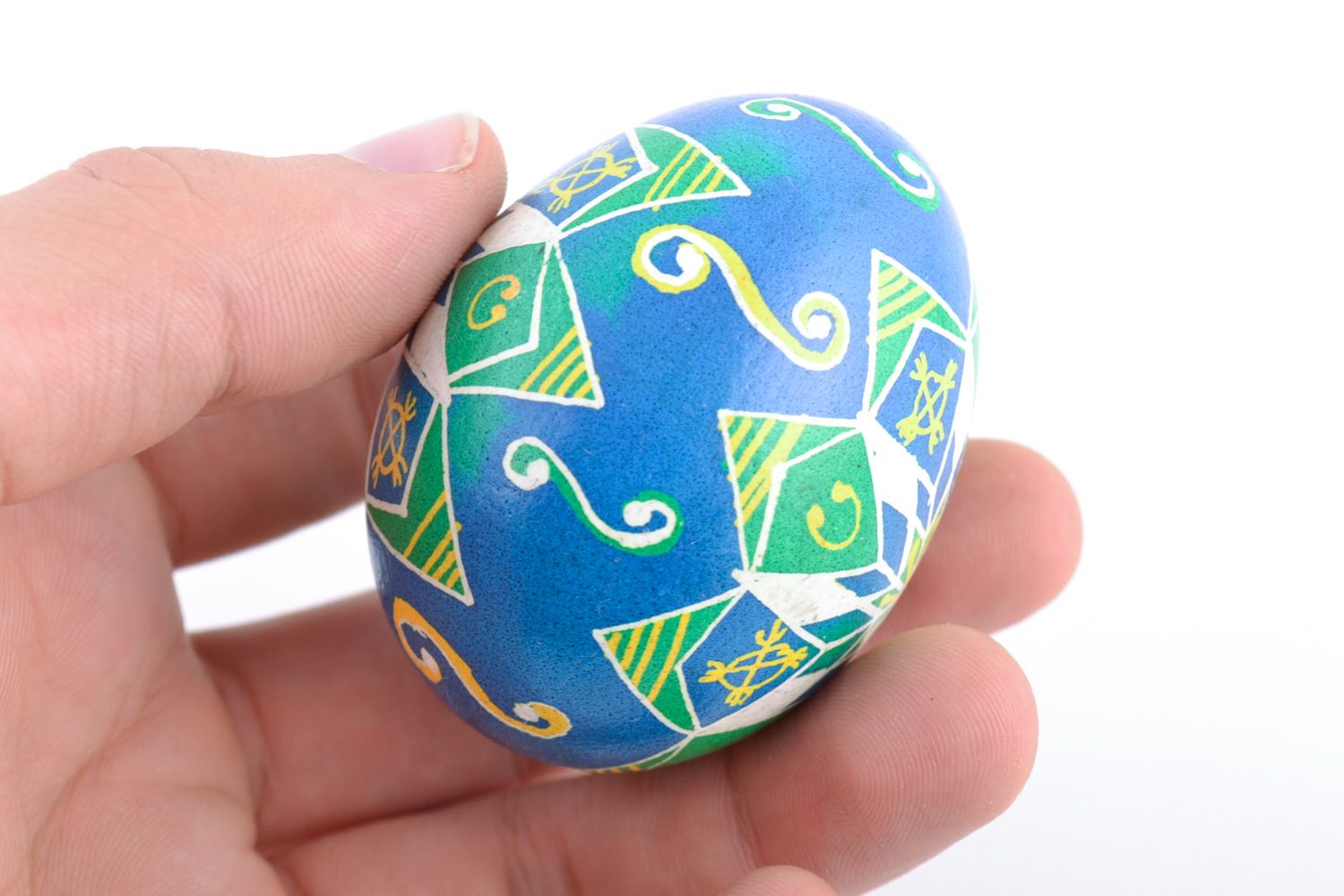Handmade painted chicken egg with pattern of blue and green colors for Easter photo 2