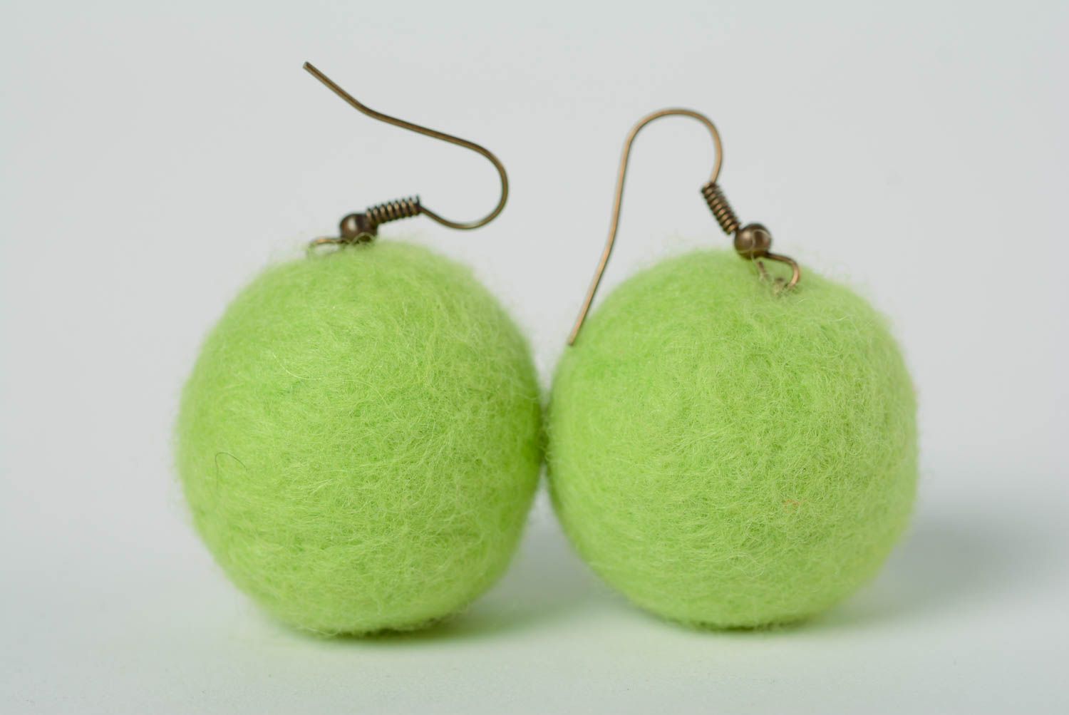 Handmade ball shaped dangling earrings felted of wool of light green color photo 1