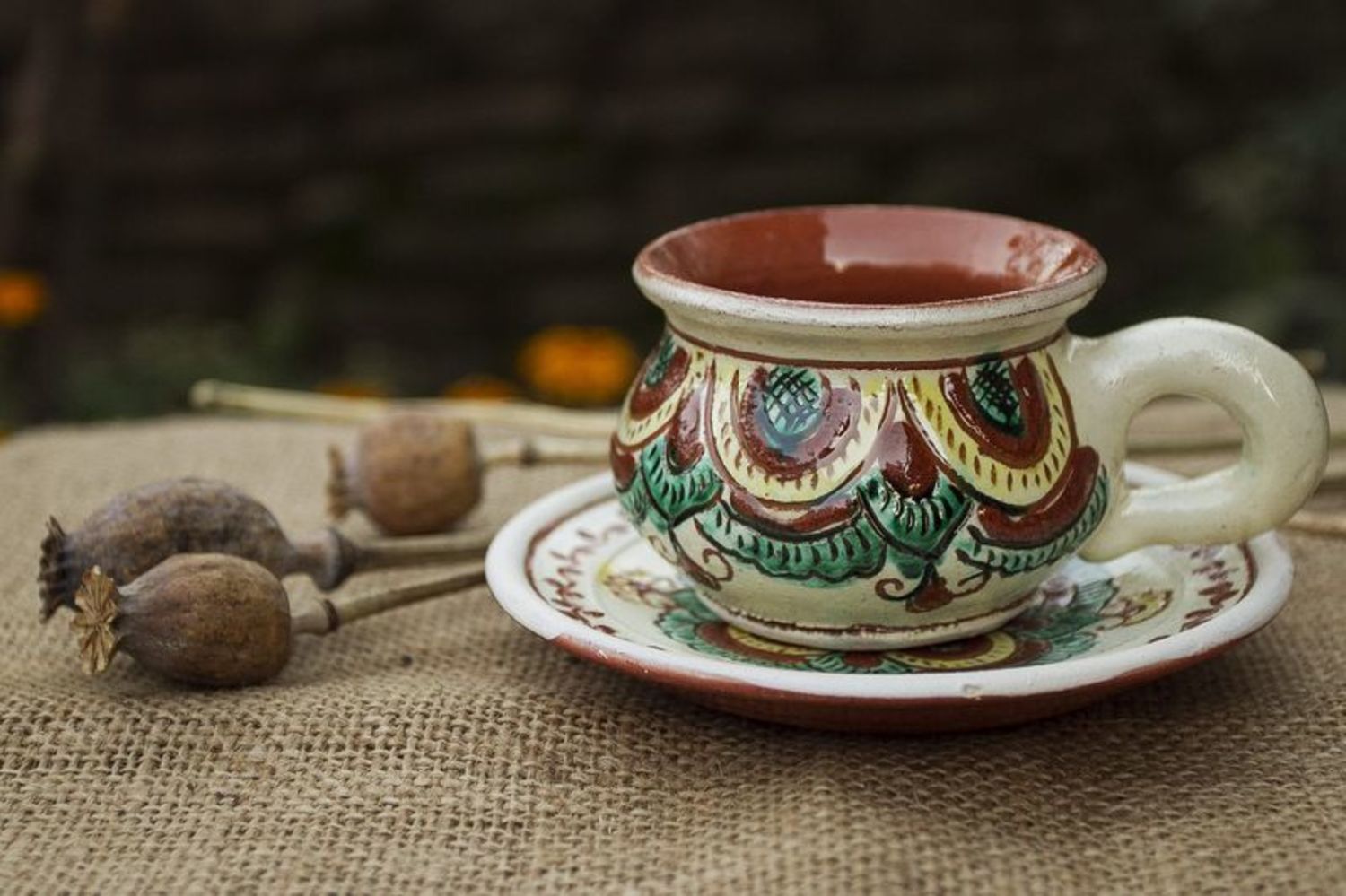 Rustic style clay coffee cup with handle and saucer with Ukrainian style brown and green color pattern photo 1