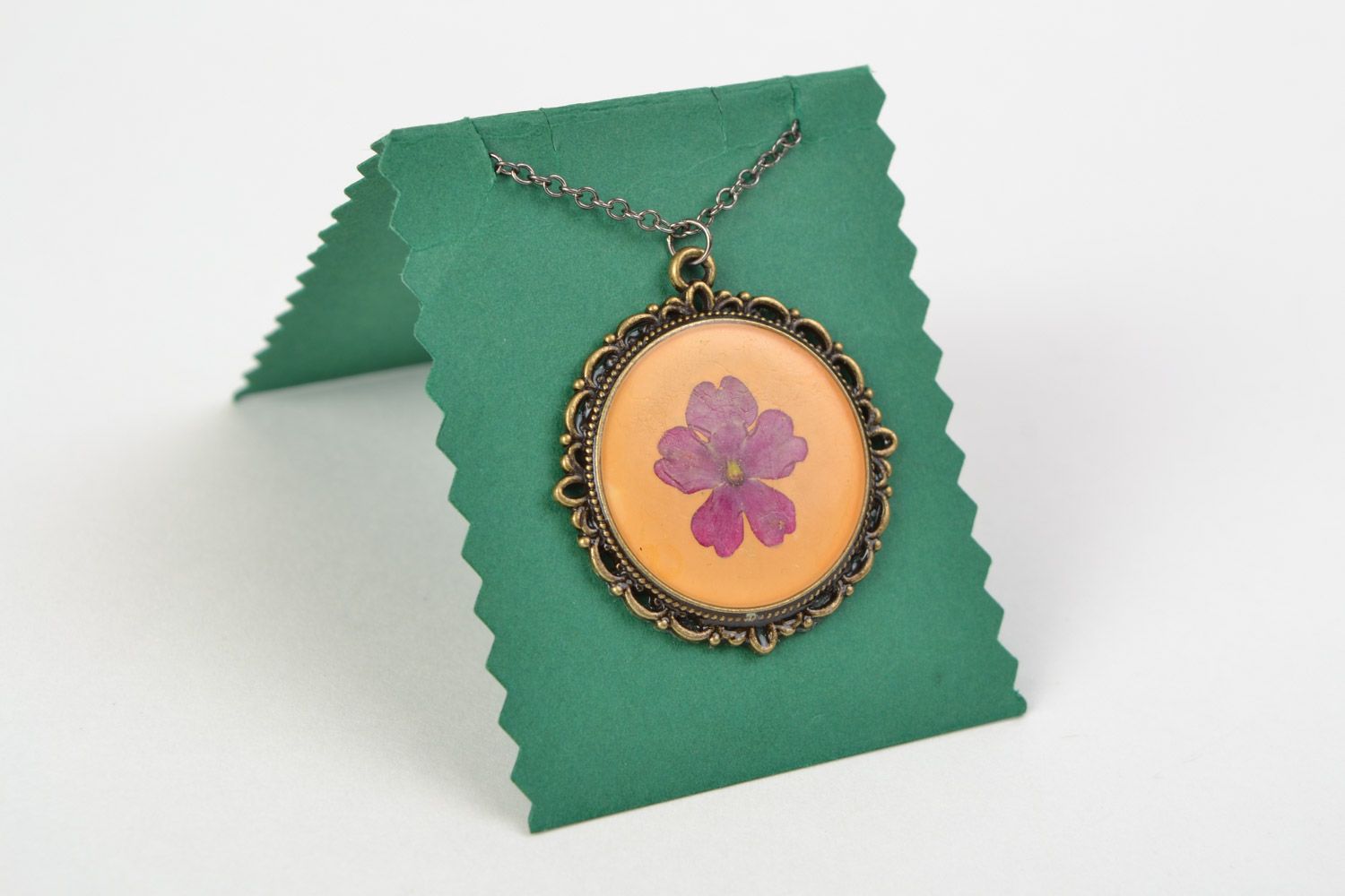 Handmade round pendant with vintage metal basis and flower in jewelry resin photo 1