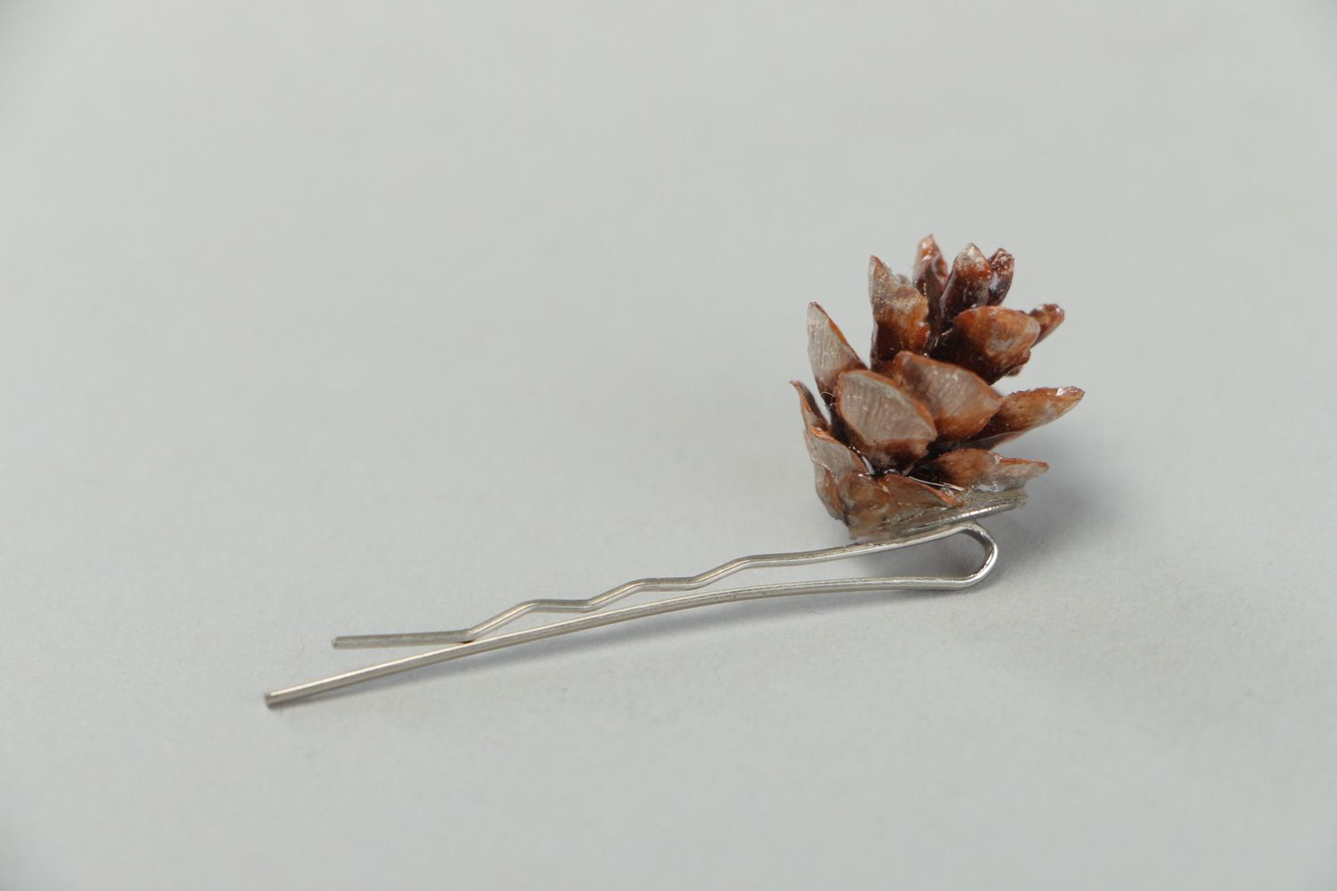 Handmade small metal hair pin with natural cone coated with epoxy resin  photo 2