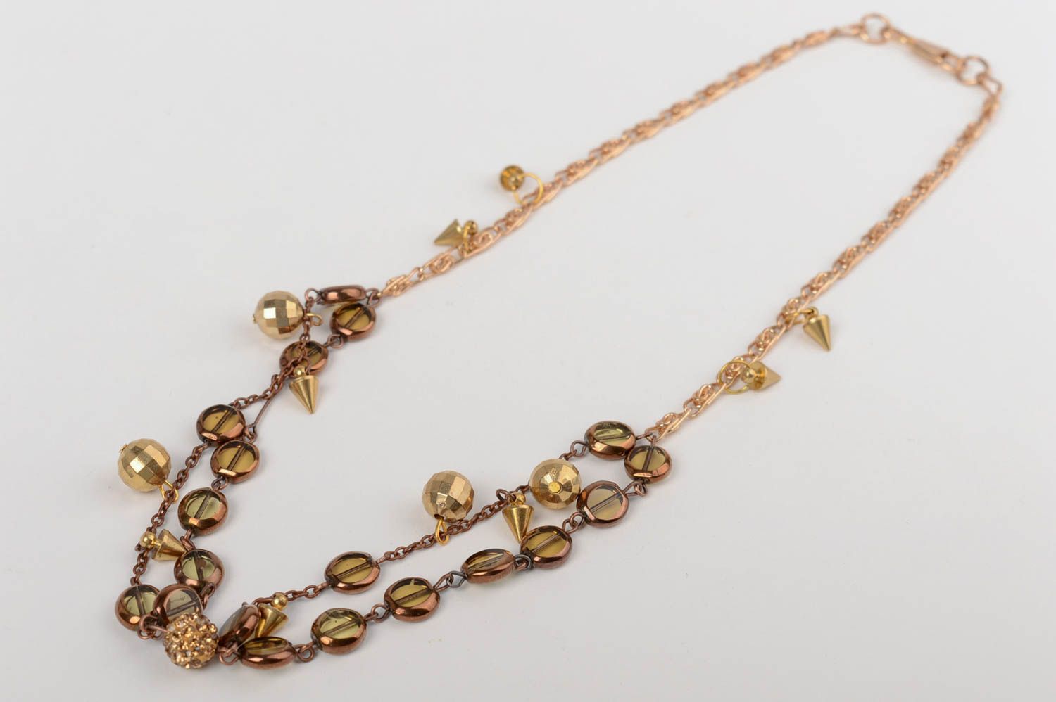 Handmade long elegant golden colored necklace with glass beads on metal chain photo 4