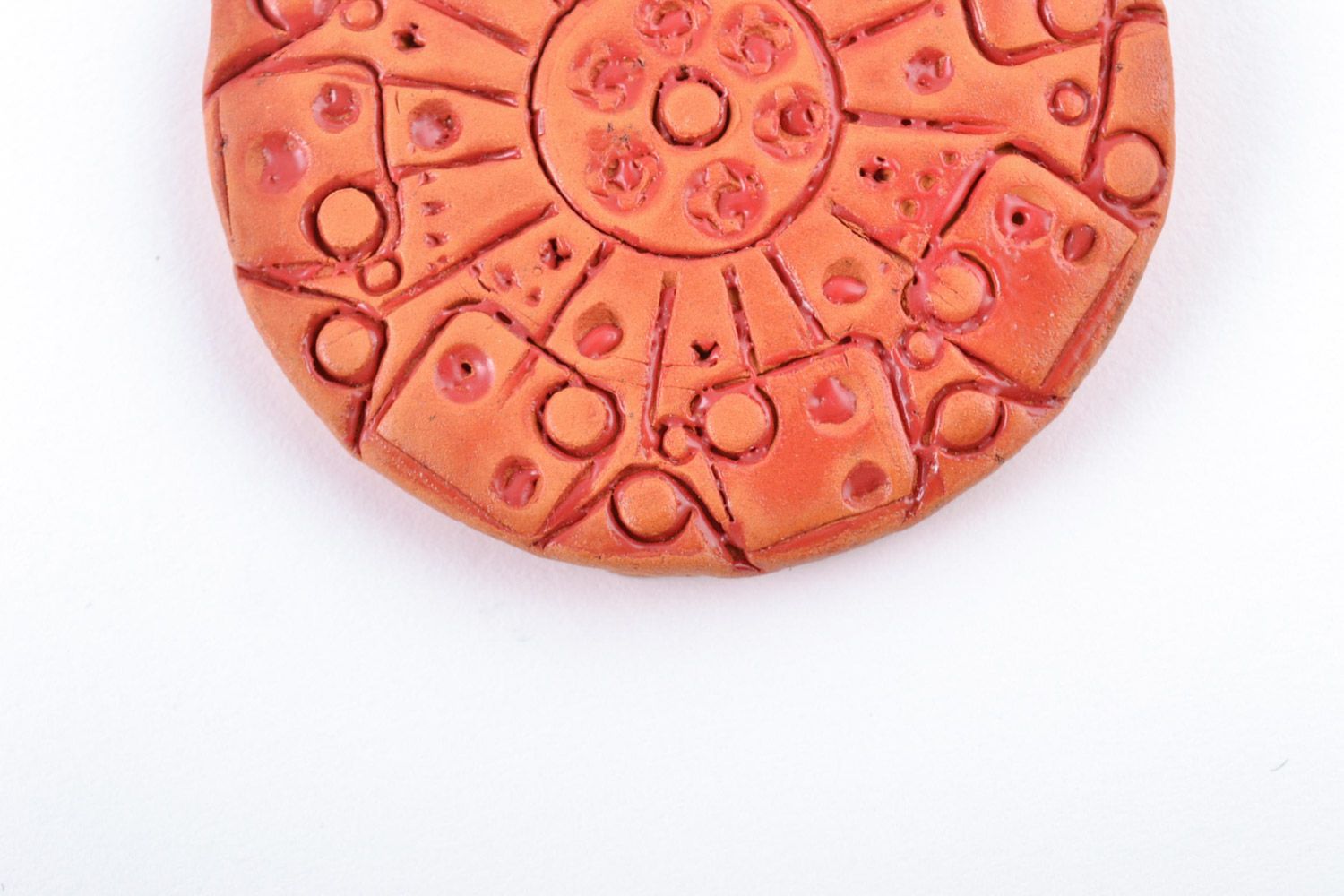Handmade bright orange ceramic pendant of round shape with ornament on cord photo 5