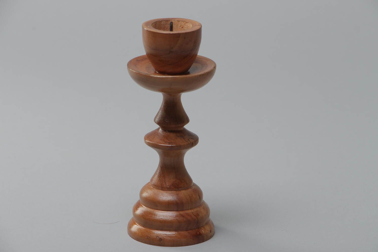 Handmade tall thin carved wooden candlestick of brown color for one candle photo 2