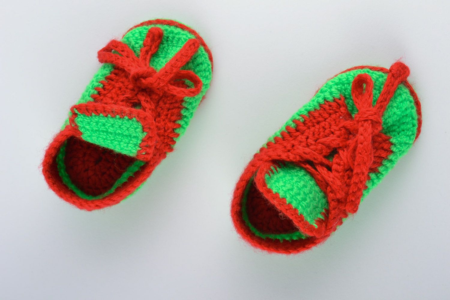 Red and green handmade knitted warm baby booties in the shape of shoes photo 4