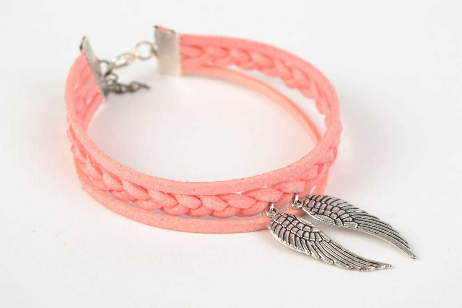 Pink handmade woven suede bracelet with metal charm in the shape of wings photo 3