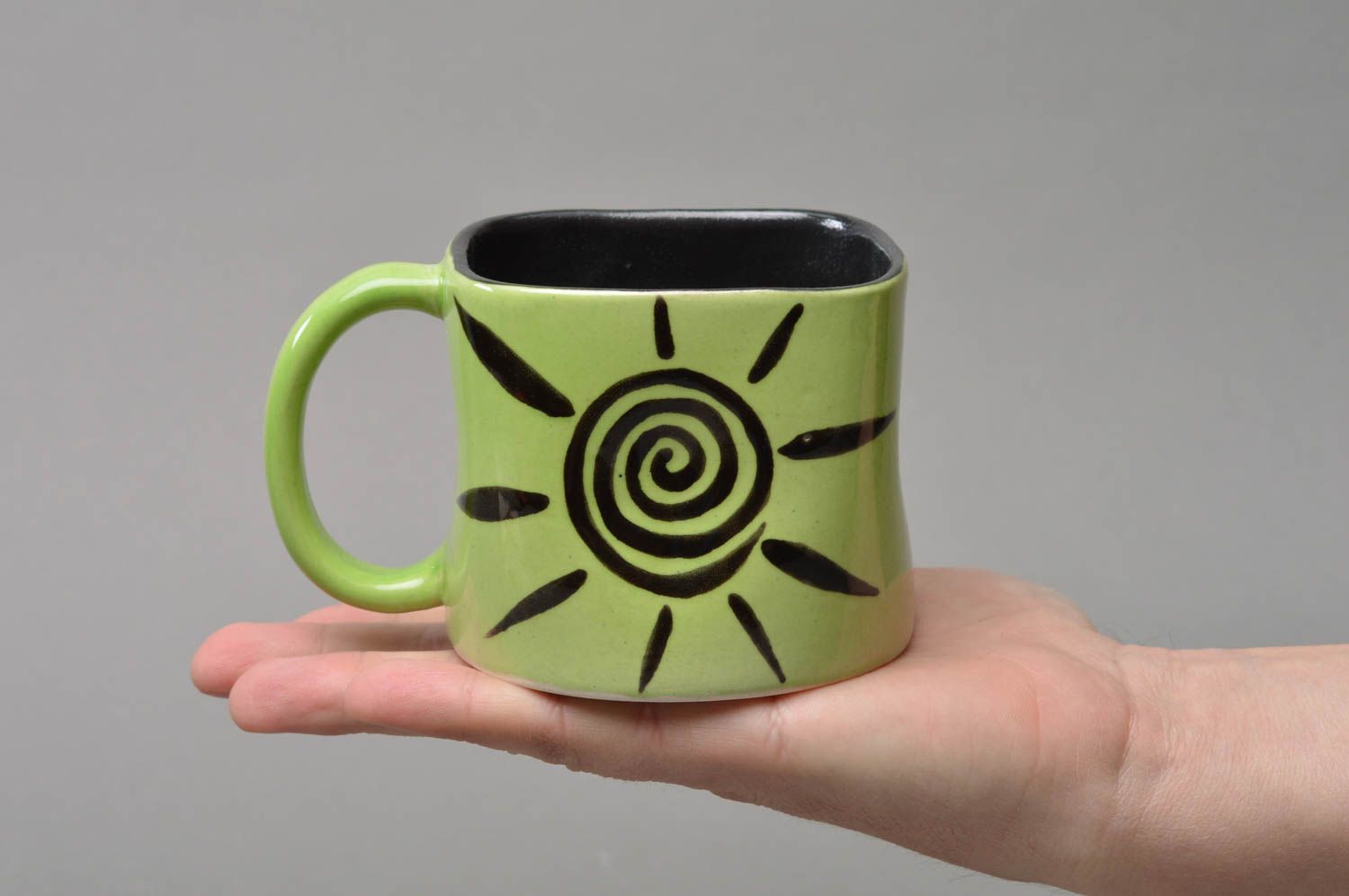 Light green and black porcelain coffee mug with handle and cave drawings sun picture photo 3