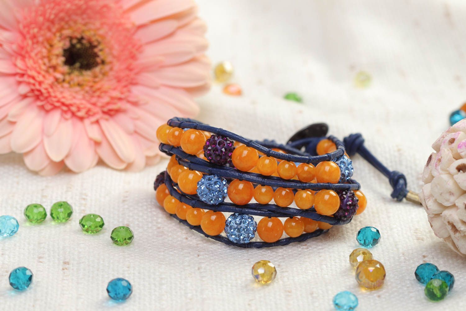 Three-layer orange beads strand bracelet on dark blue cord photo 1