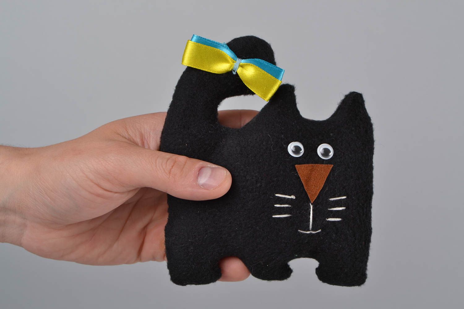 Handmade black soft toy cat made of fleece with colorful bow photo 2