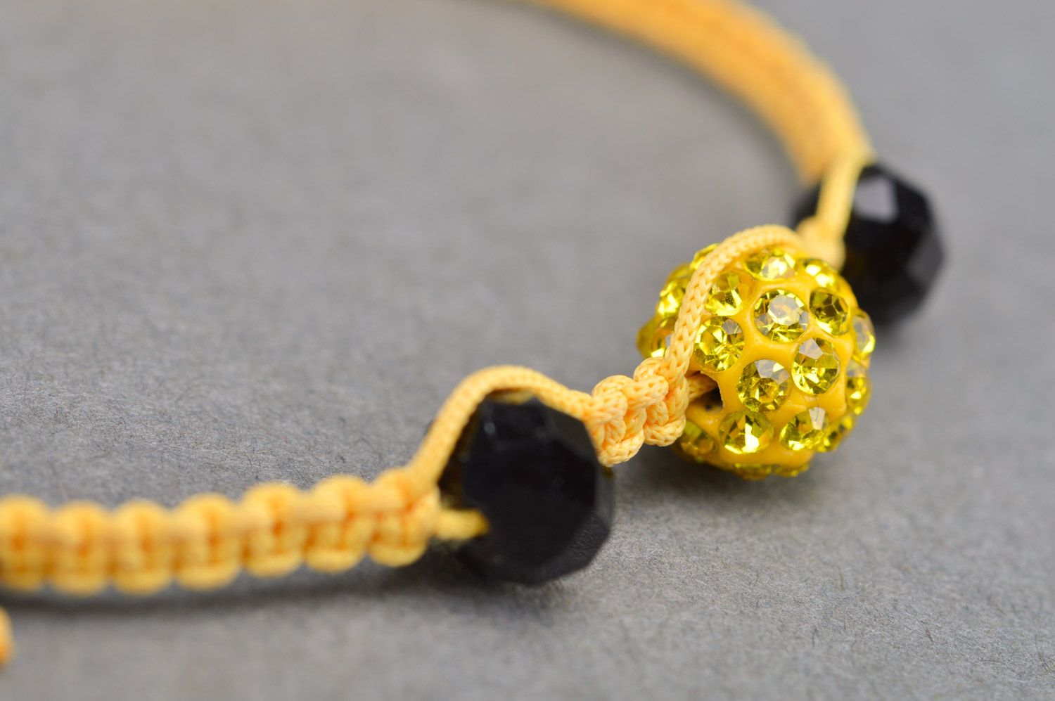 Stylish gentle handmade wrist bracelet woven of yellow threads and black beads photo 4