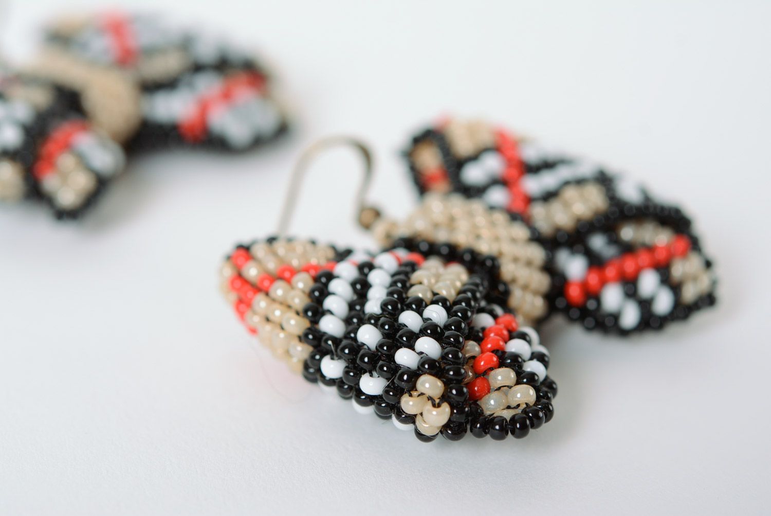 Handmade dangle earrings woven of beads beige checkered bows for girls photo 4