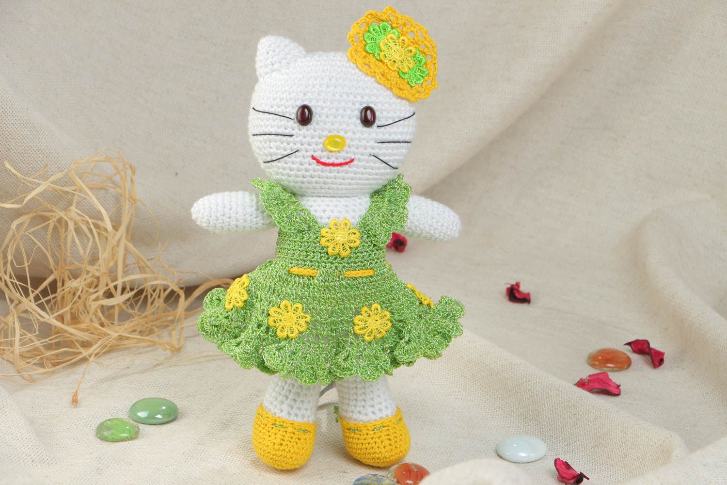 Soft handmade decorative crocheted toy cat in a green dress made of acrylic threads photo 1