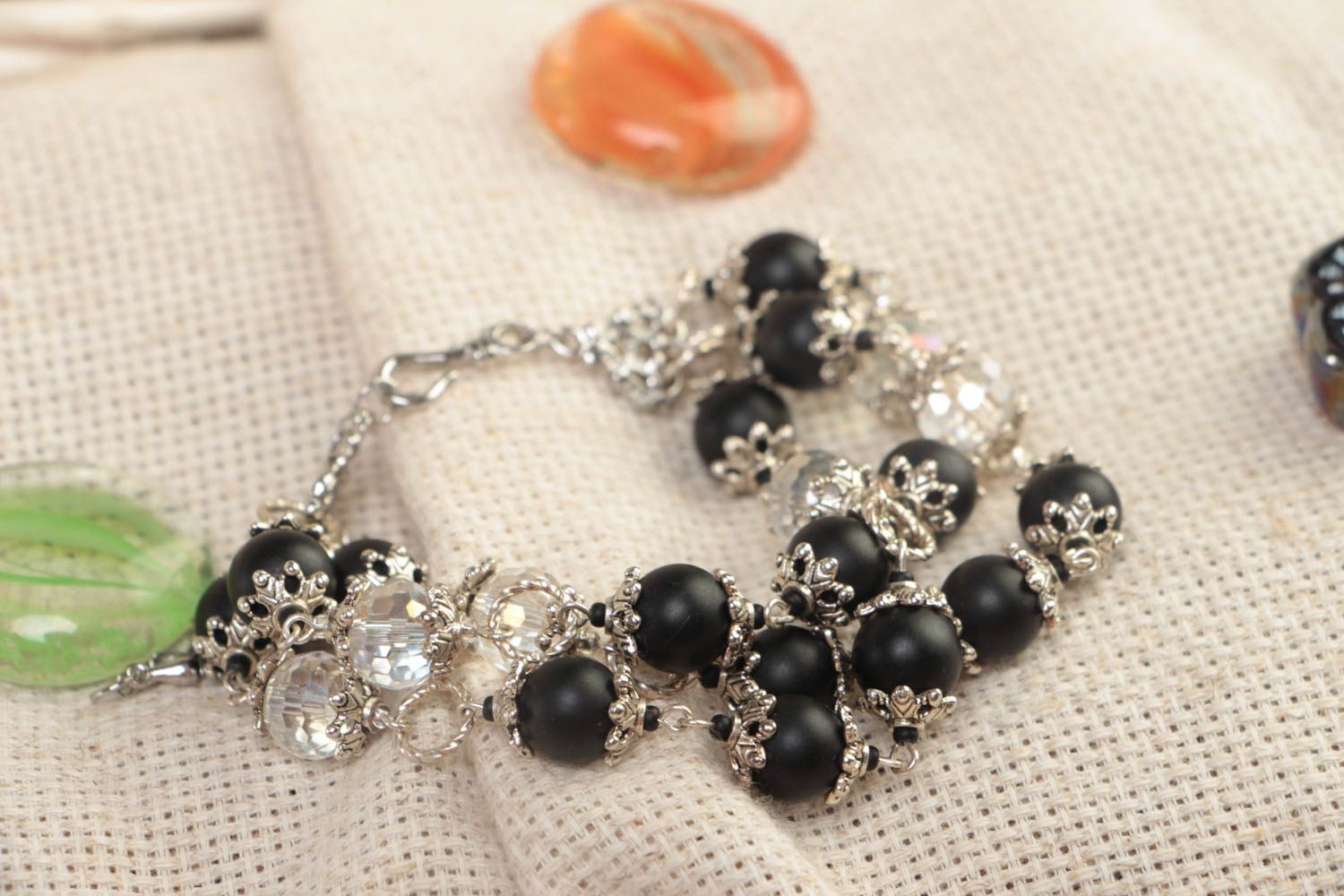 Three-layer beaded gemstone bracelet with black beads and metal charms photo 1