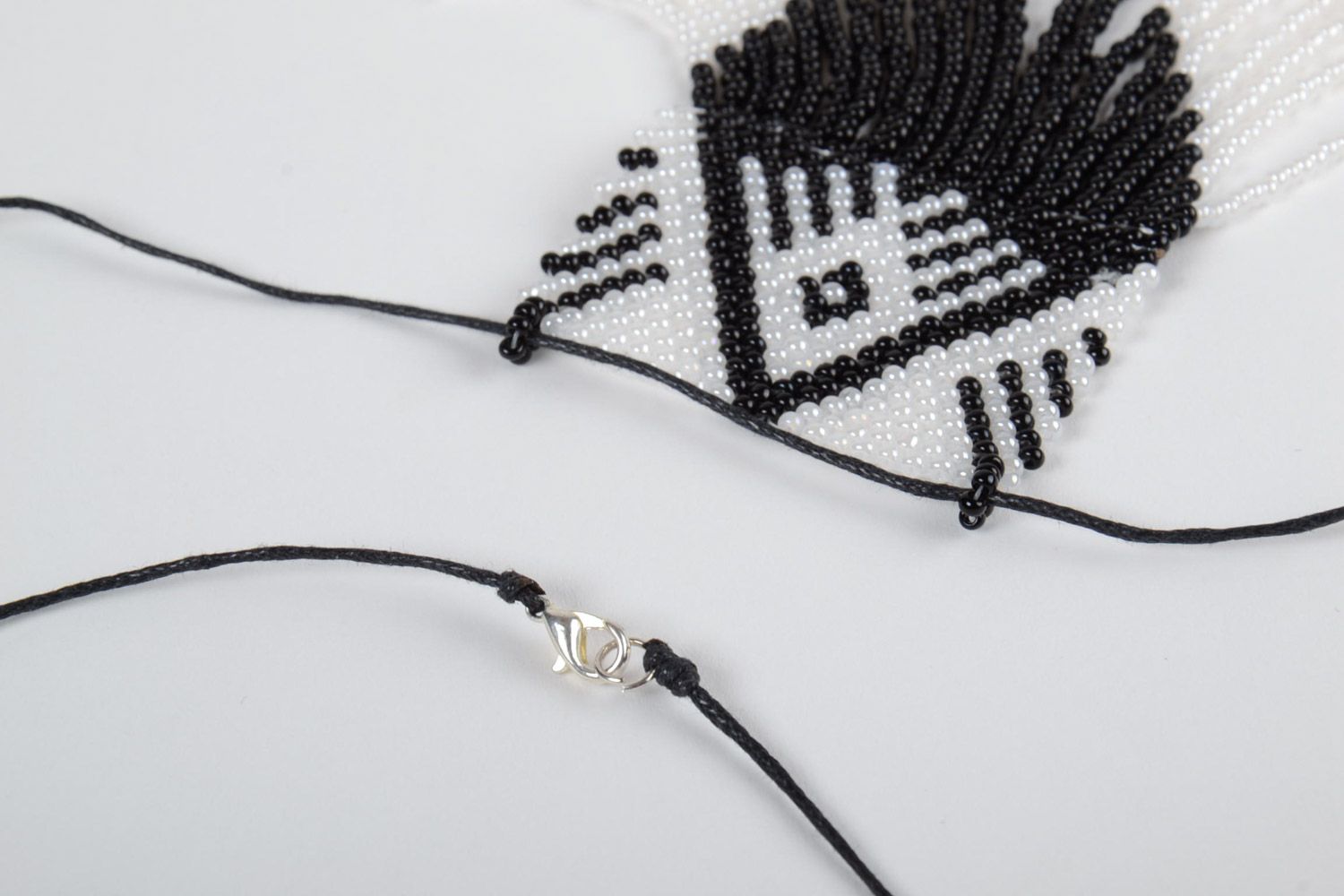 Black and white handmade beaded pendant with fringe and synthetic cord photo 4