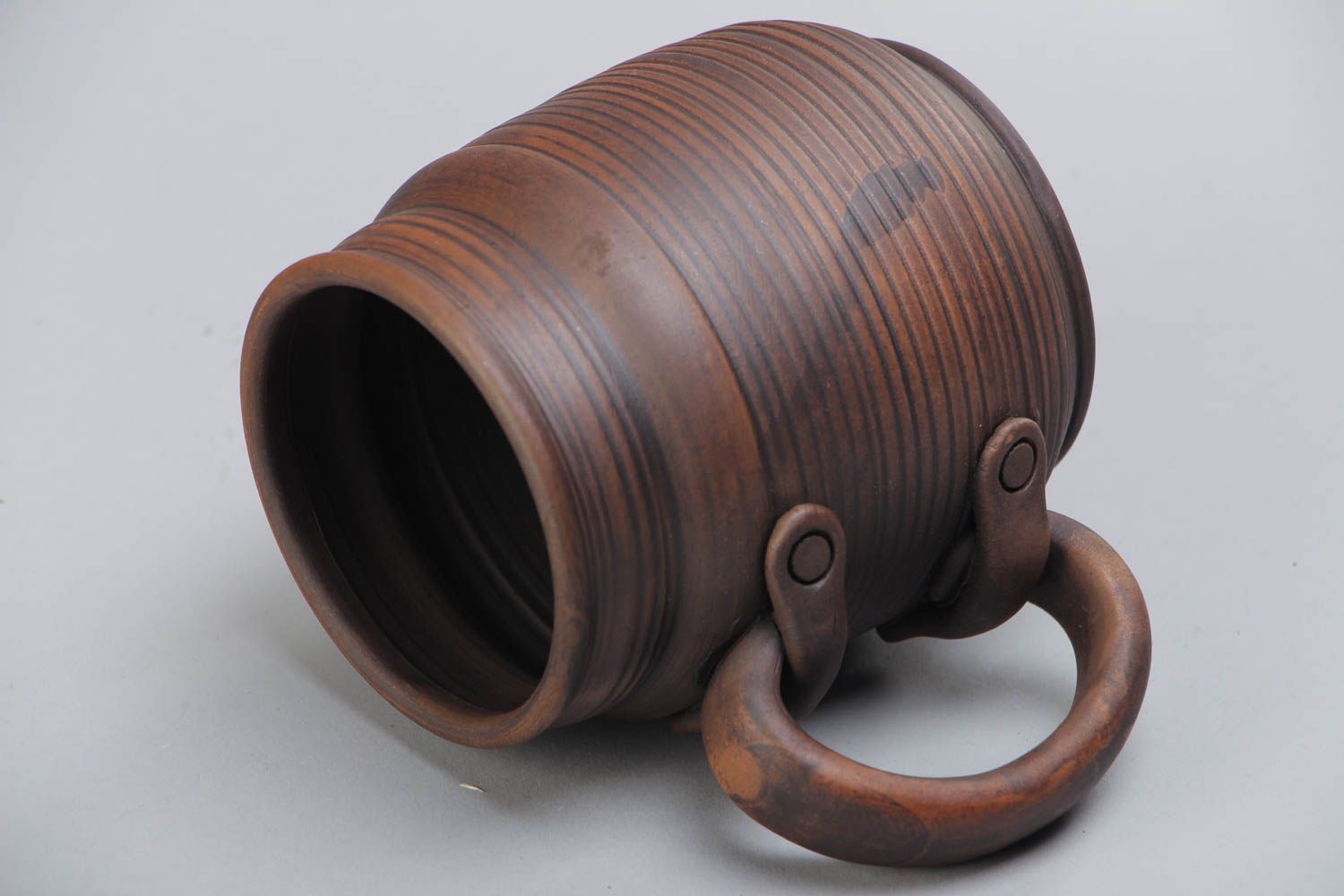Handmade decorative dark brown ceramic beer mug kilned with milk in ethnic style photo 4