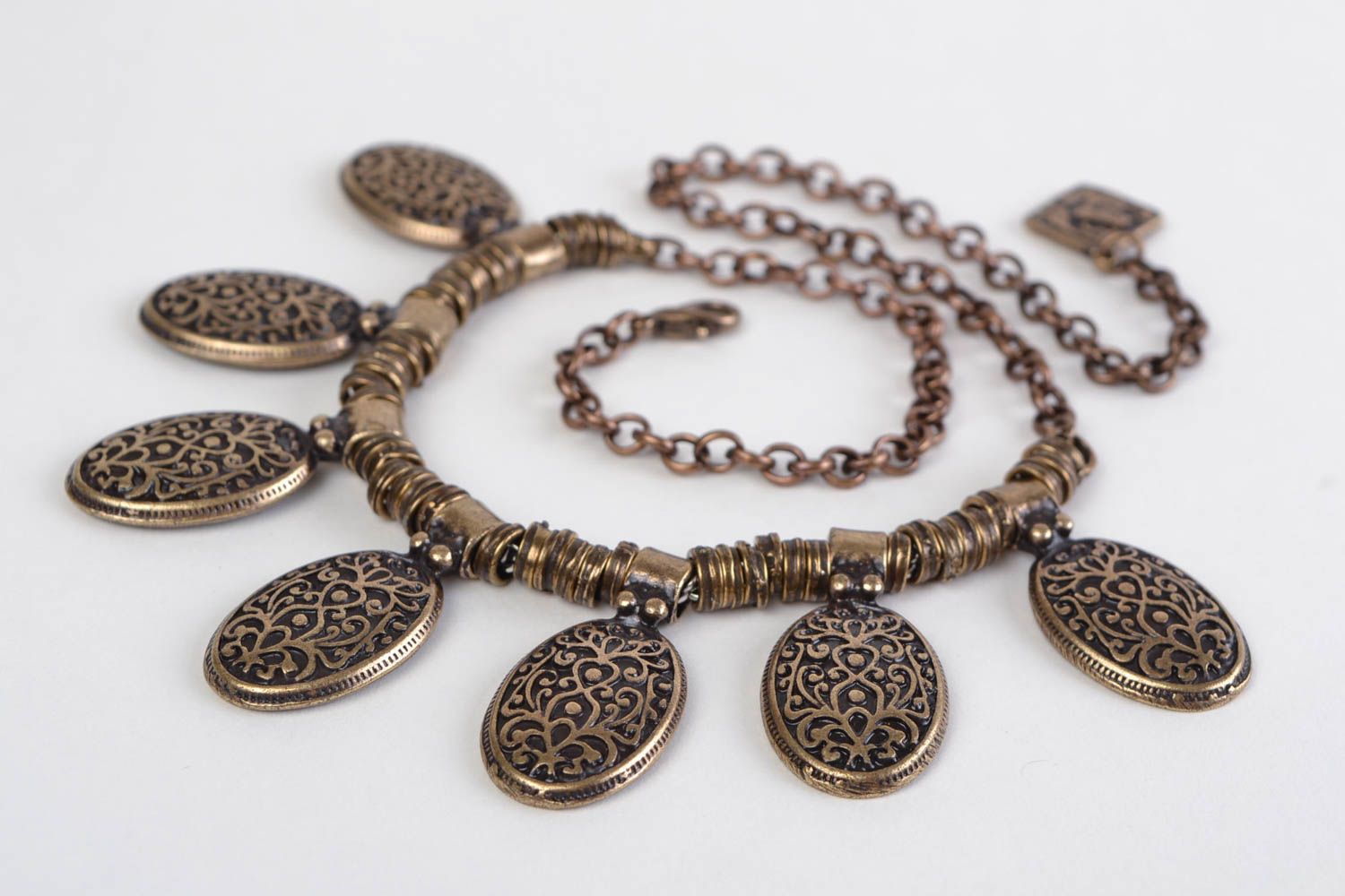 Handmade designer metal necklace of bronze color in ethnic style photo 3