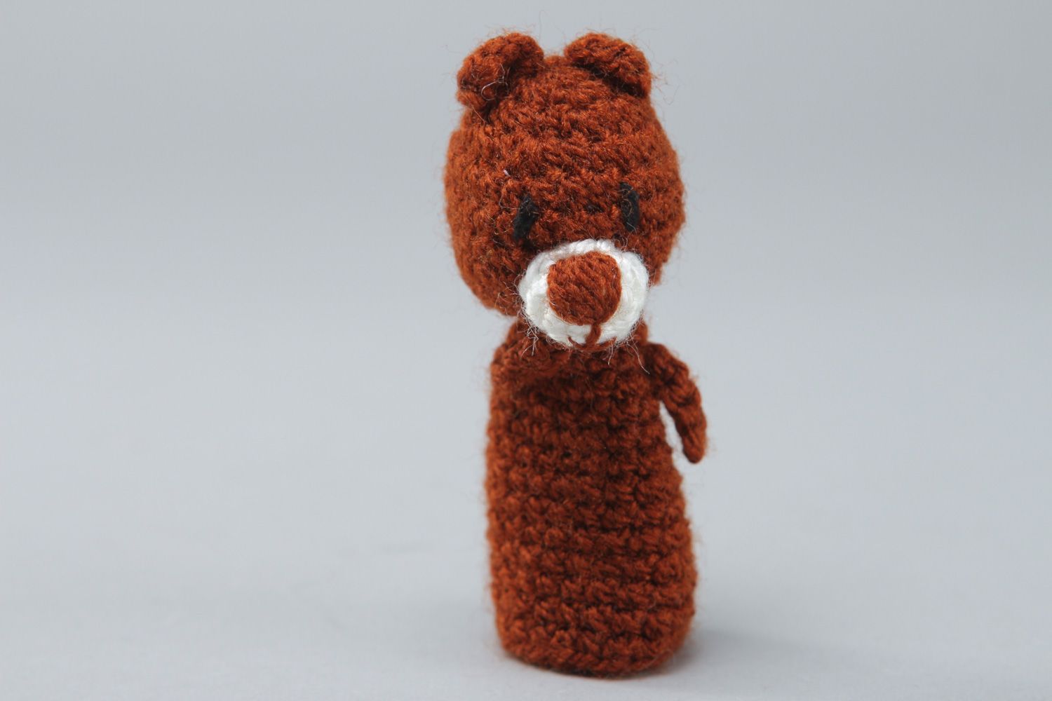 Handmade finger puppet in the shape of brown bear crocheted of acrylic threads photo 1