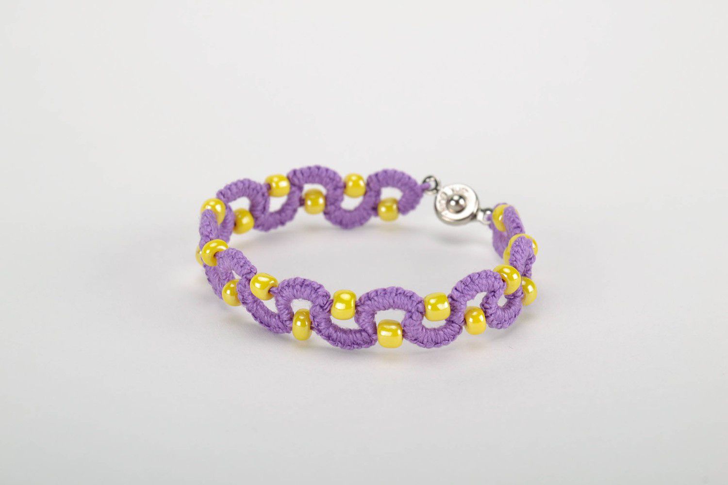 Purple bracelet woven from threads photo 3