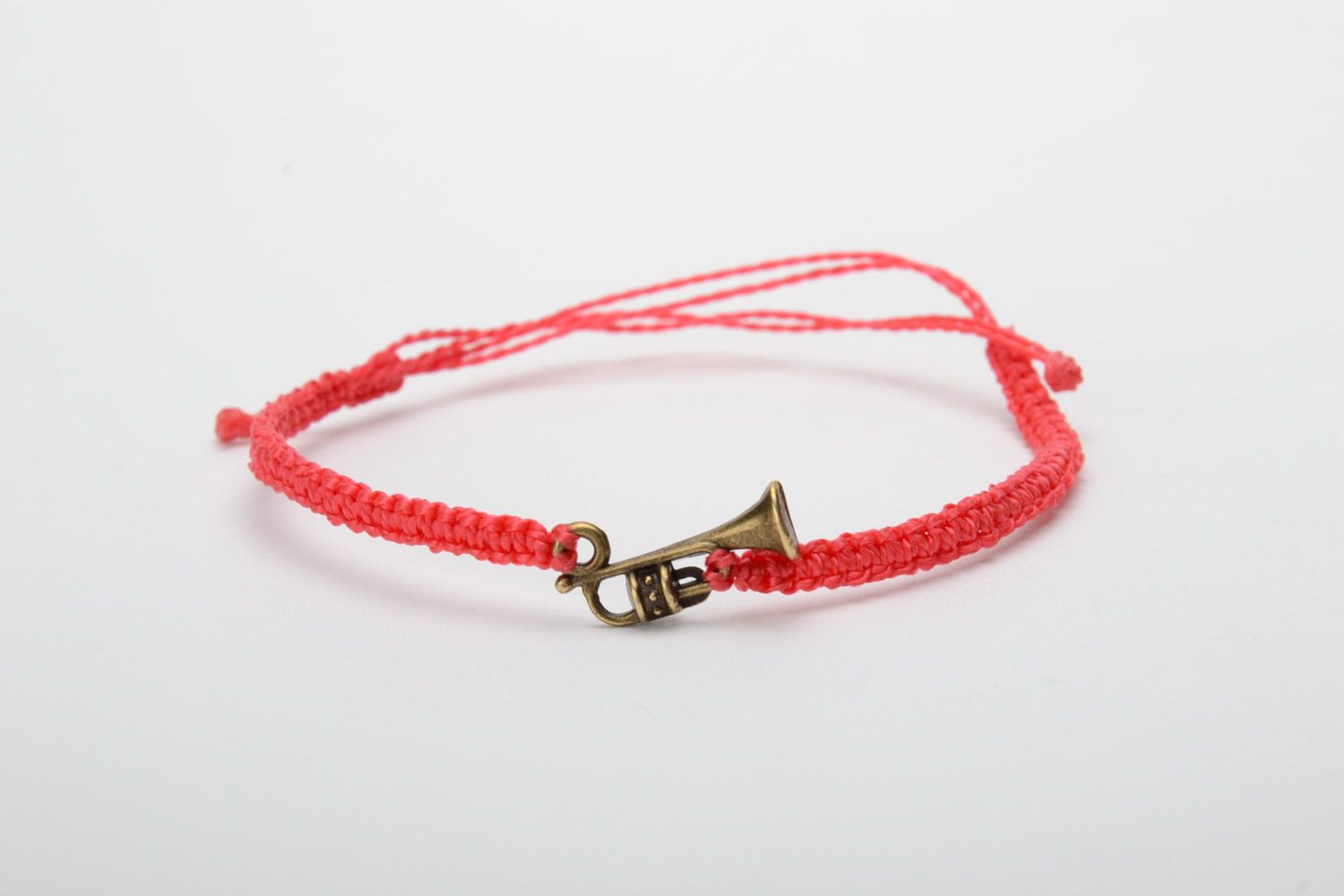 Handmade red woven capron thread bracelet with metal charm in the shape of saxophone photo 5