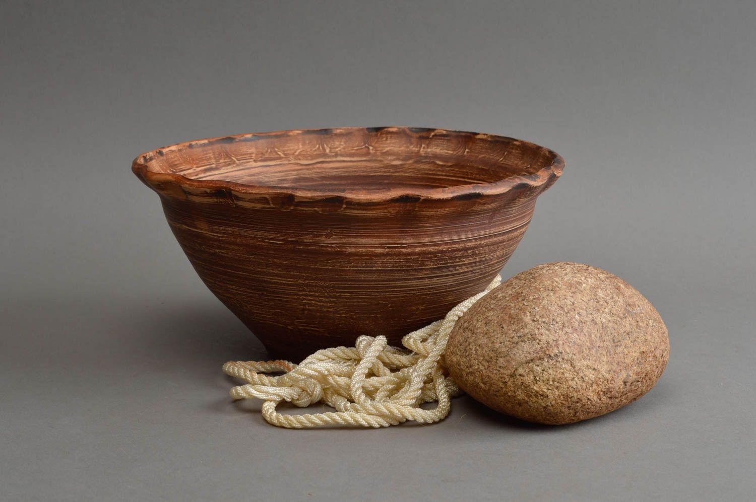 Handmade stylish ethnic ceramic tall bowl with waved edge and narrow bottom photo 1