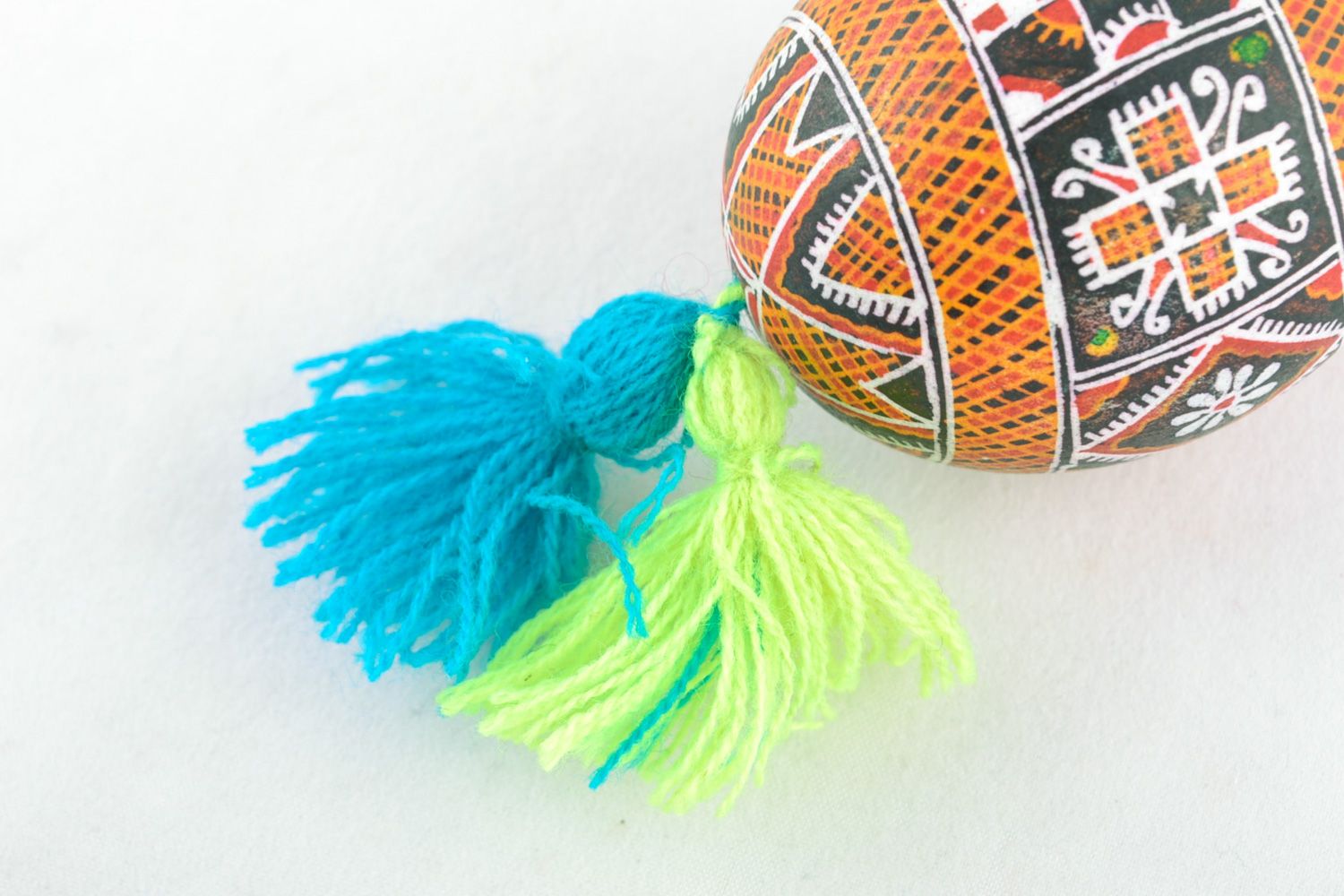 Handmade hanging Easter egg painted using wax technique with yellow and blue tassels photo 4