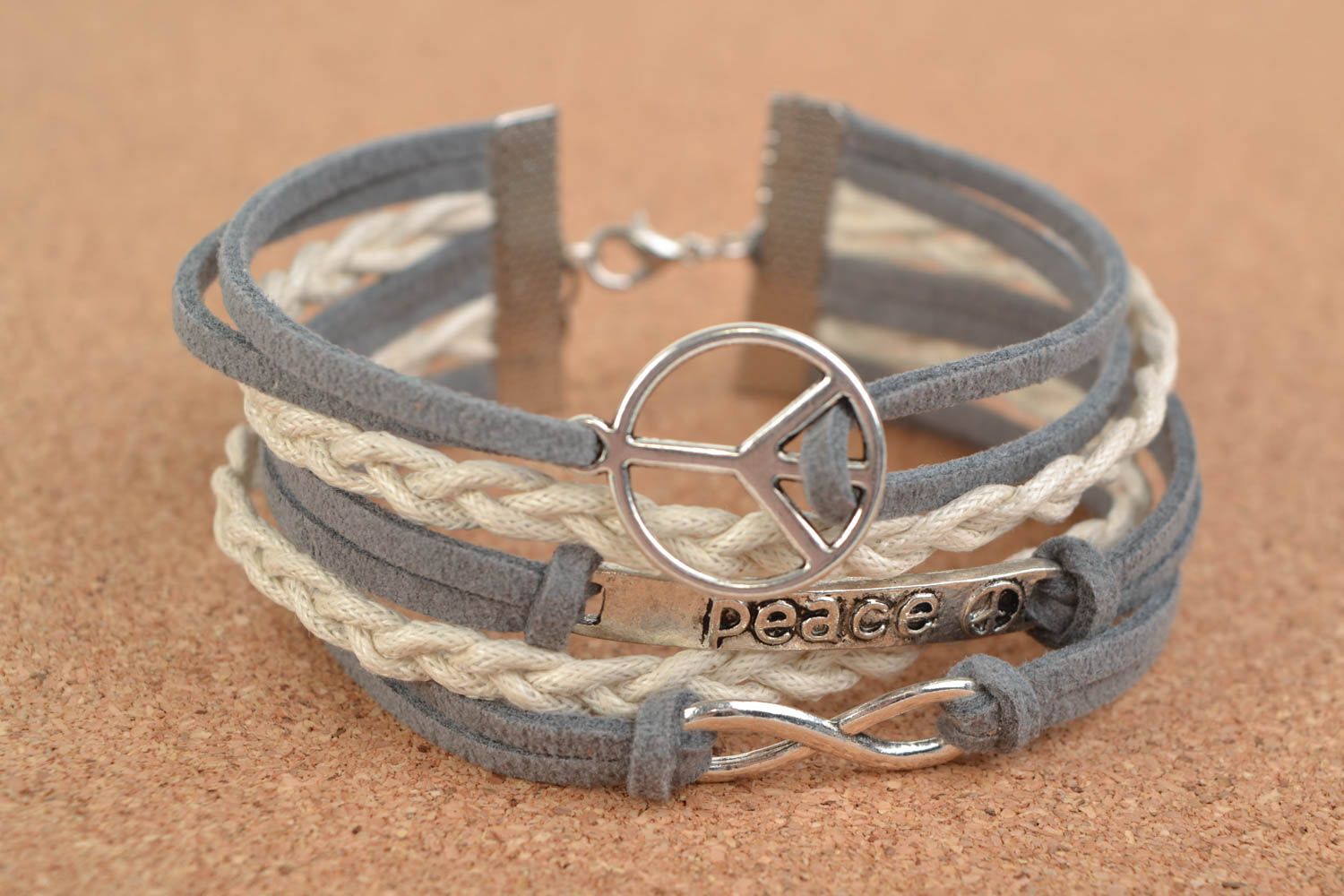 Gray and white handmade woven suede cord bracelet with pacific sign photo 1