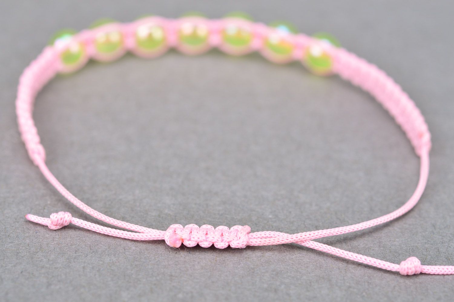 Beautiful stylish handmade children's bracelet woven of threads and beads of gentle pink color photo 5