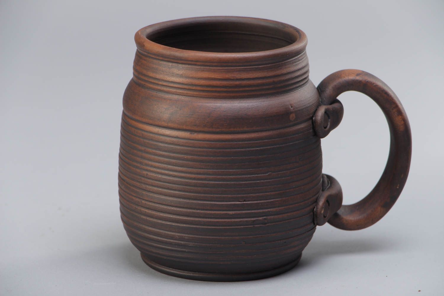 Handmade decorative dark brown ceramic beer mug kilned with milk in ethnic style photo 2