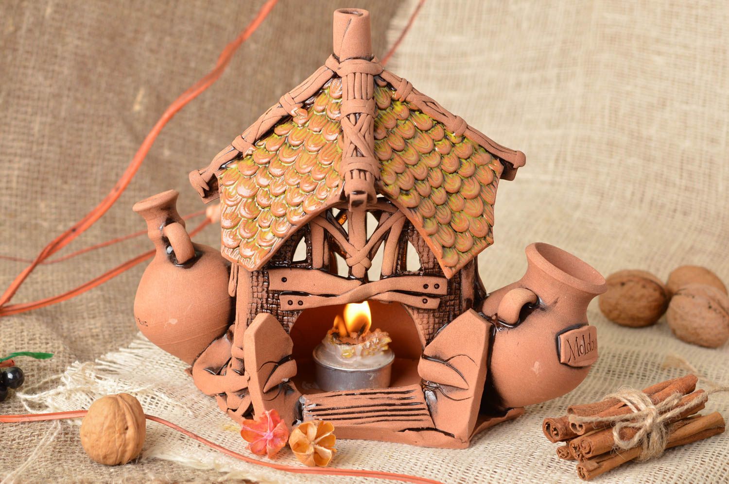 Handmade designer decorative ceramic candle holder styled on house for interior photo 1