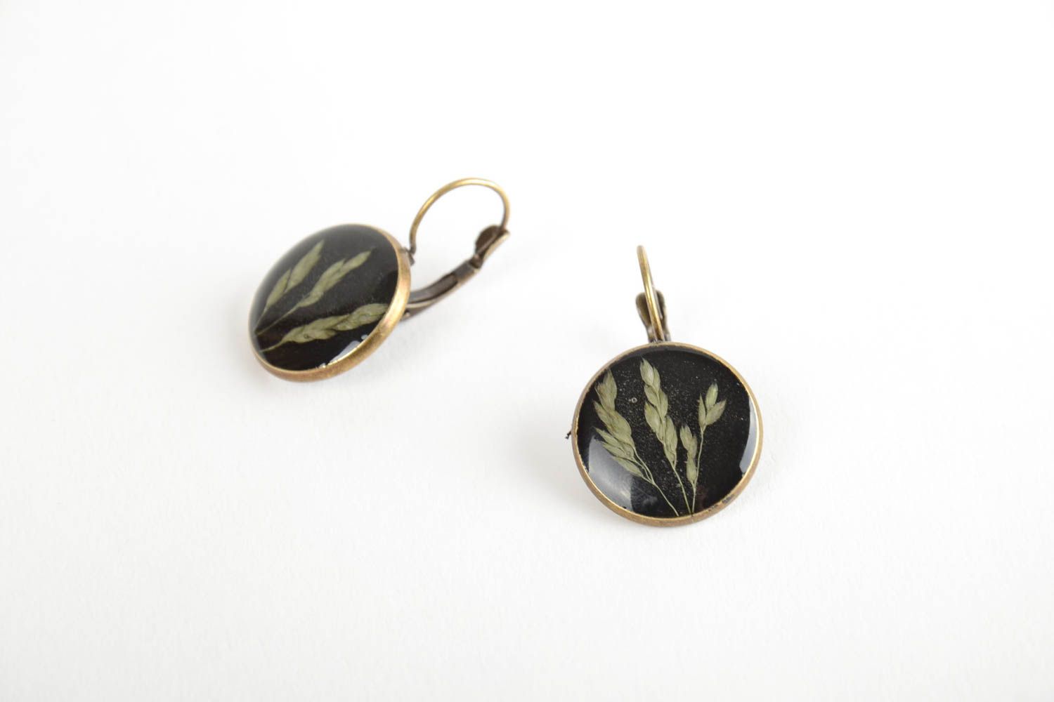 Small handmade dark round dangling earrings with natural plants in epoxy resin photo 3