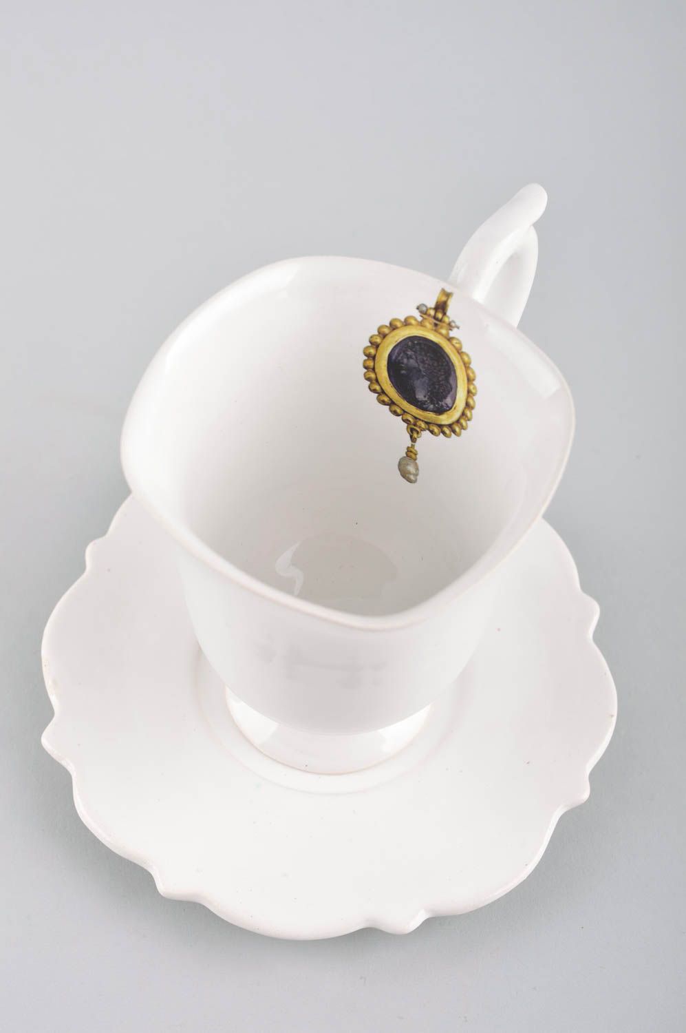 White plain porcelain teacup on the stand in elegant design with handle and saucer photo 3