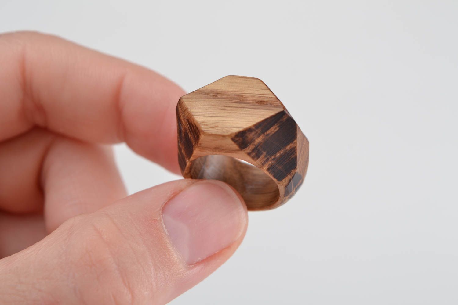 Handmade stylish designer jewelry ring cut out of natural oak wood with facets photo 2
