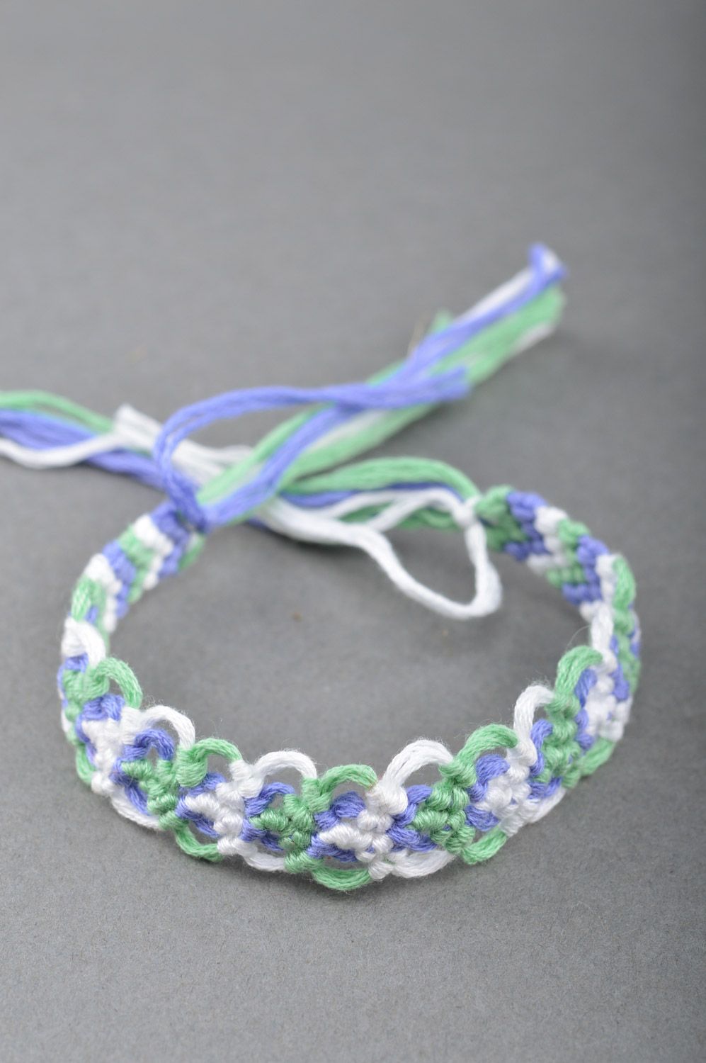 Thin handmade friendship wrist bracelet woven of embroidery floss in tender colors photo 2